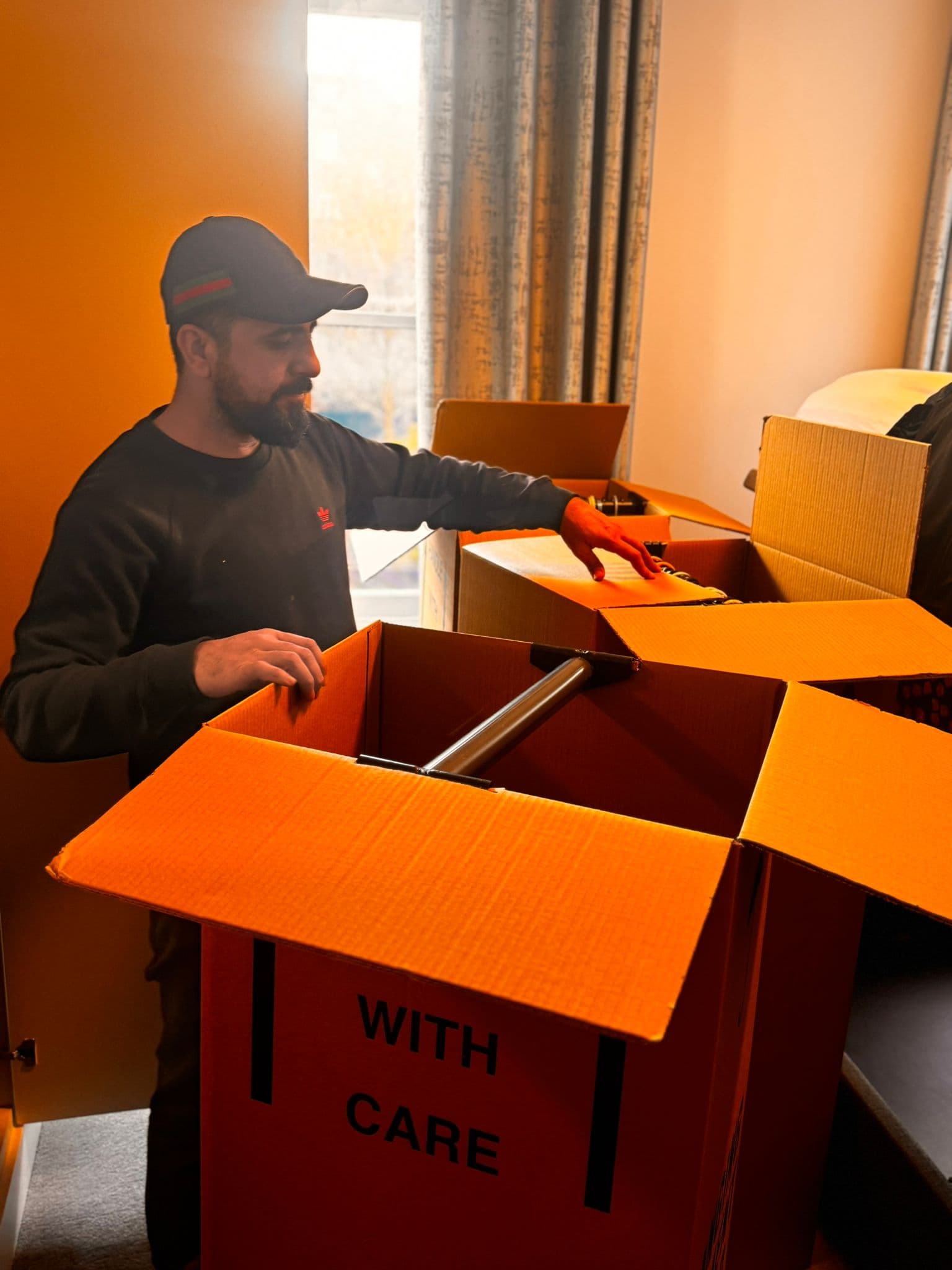 Packed removal boxes stacked and ready for loading — organised by room for efficient move