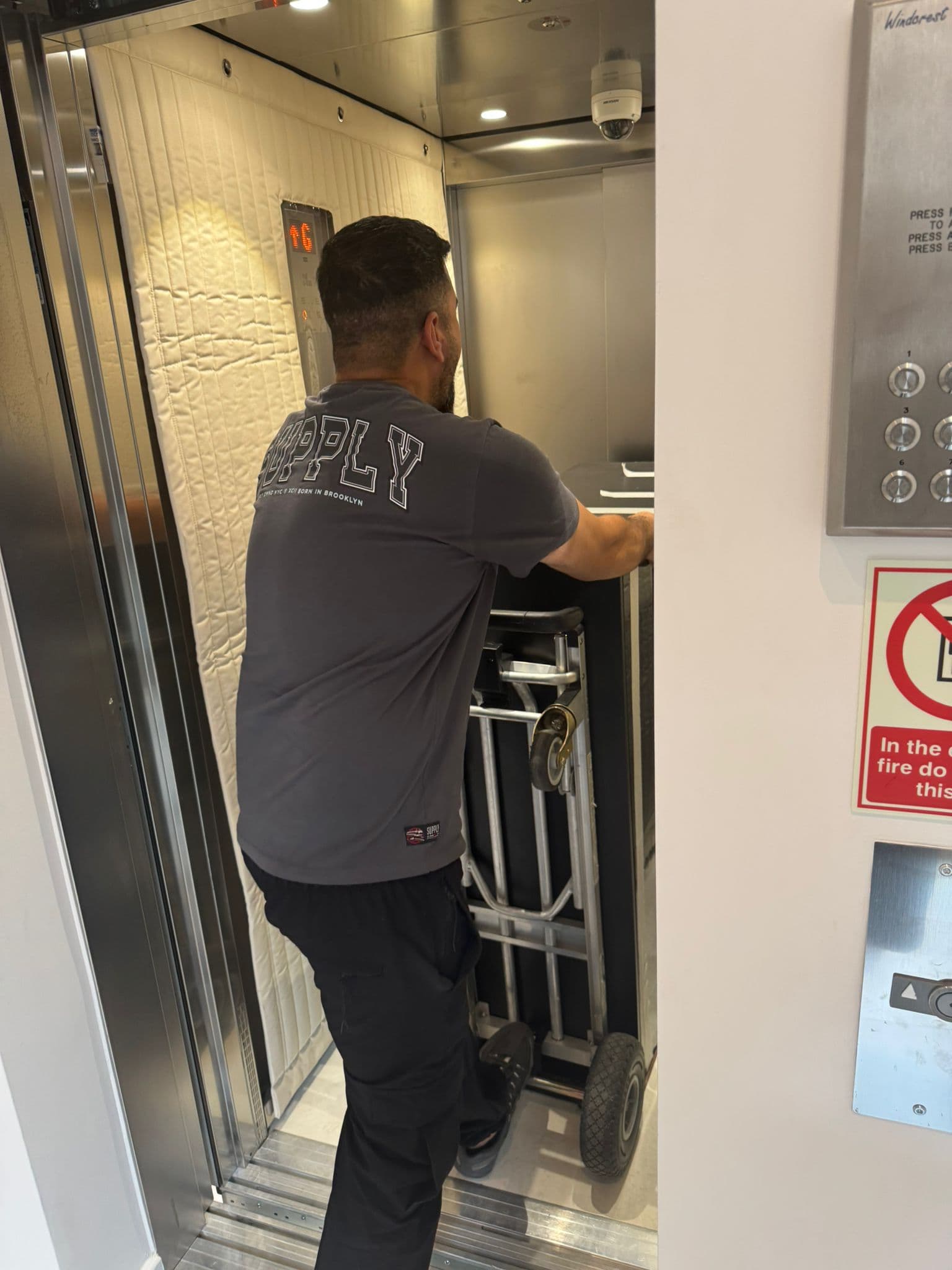 Removal team carrying boxes in London — careful loading by trained, DBS-checked professionals