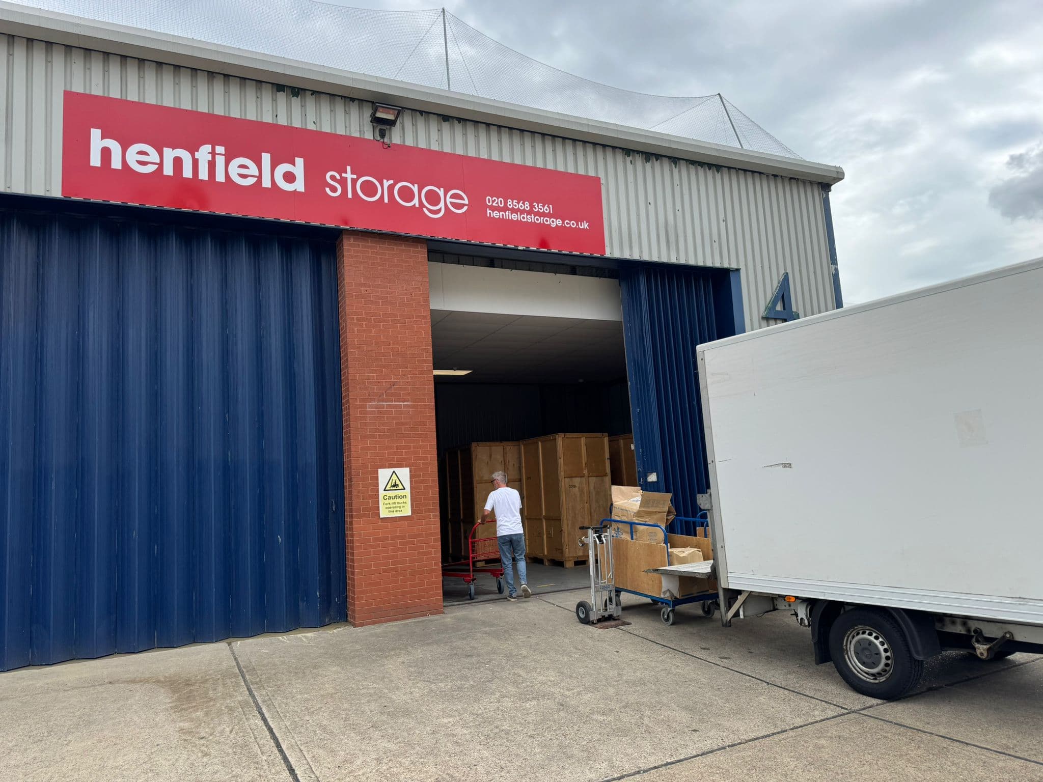 Removal van being loaded in London — careful stacking and securing of household items